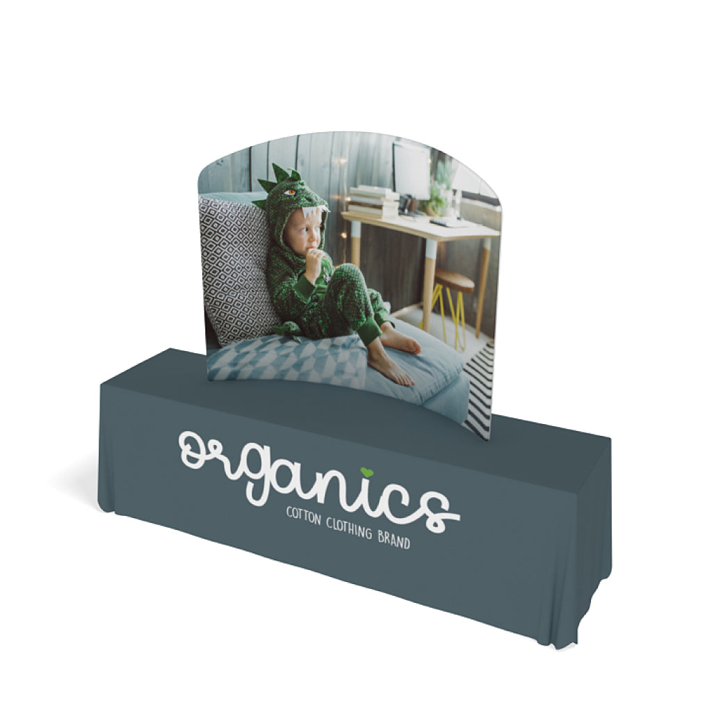 Curved tabletop display with child image and branded table cover for trade show exhibits