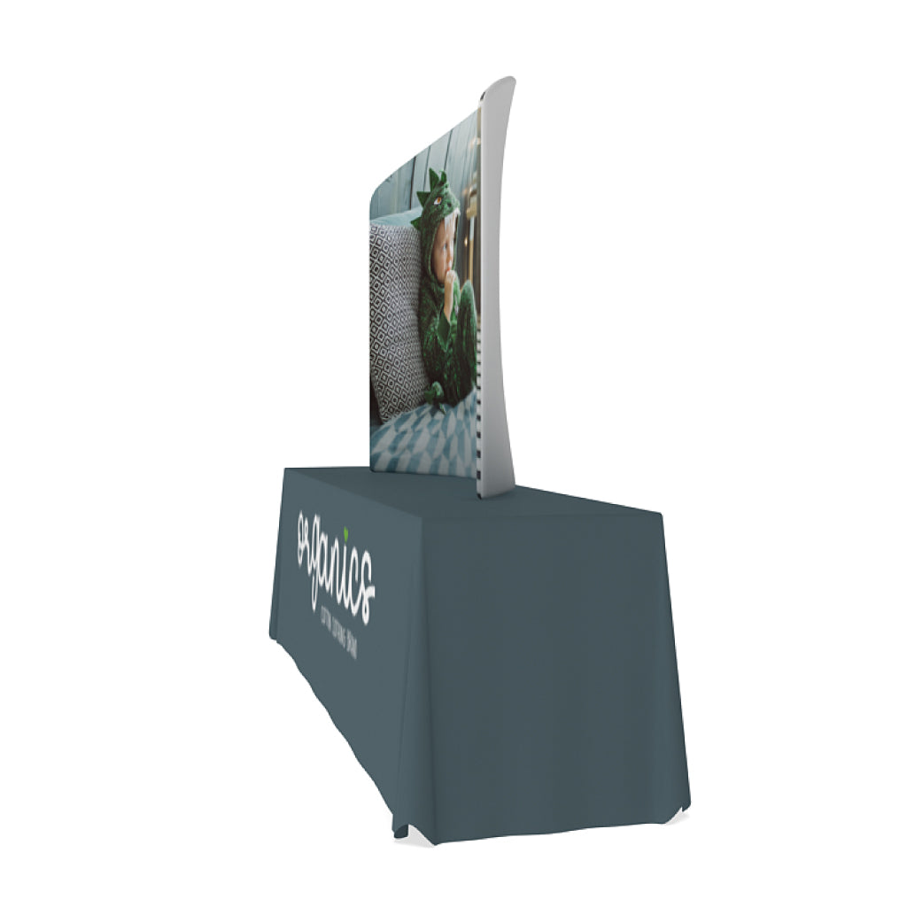 Curved tabletop display with custom graphic and branded table cover for trade shows and events