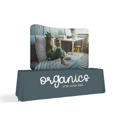 Curved tabletop trade show display with child image and branded fabric table cover for exhibitions