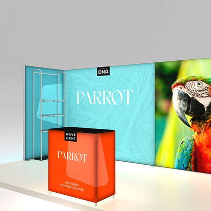 Trade show display featuring inflatable lightbox counter and large graphic wall with parrot image