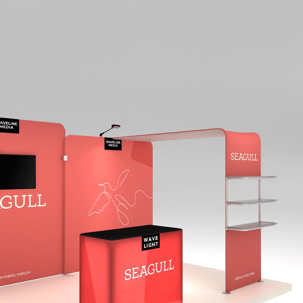 Trade show display booth with branded fabric panels, shelving, and counter for exhibitions and events