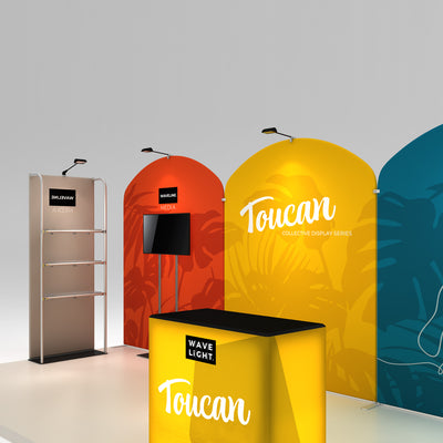 Trade show display with Toucan collective series backdrop, media stand, and illuminated reception counter