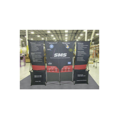 Expandable trade show display with printed fabric panels showcasing IT and cybersecurity services in a large indoor venue