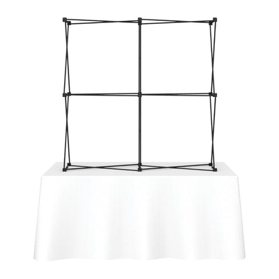 Portable trade show tabletop display frame on table with white tablecloth for exhibitions and events