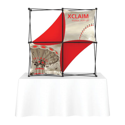 Compact fabric pop-up display with printed graphics on tabletop for trade shows and exhibitions