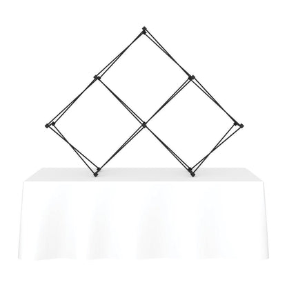 Expandable quad pyramid frame on table for trade show and exhibition display
