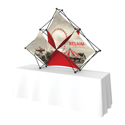 Xclaim fabric pop-up display on table for trade shows and exhibitions featuring graphic panels