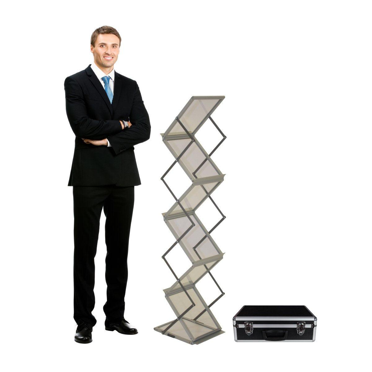 Foldable literature rack with multiple shelves and carrying case beside a man in business attire for trade shows and exhibitions
